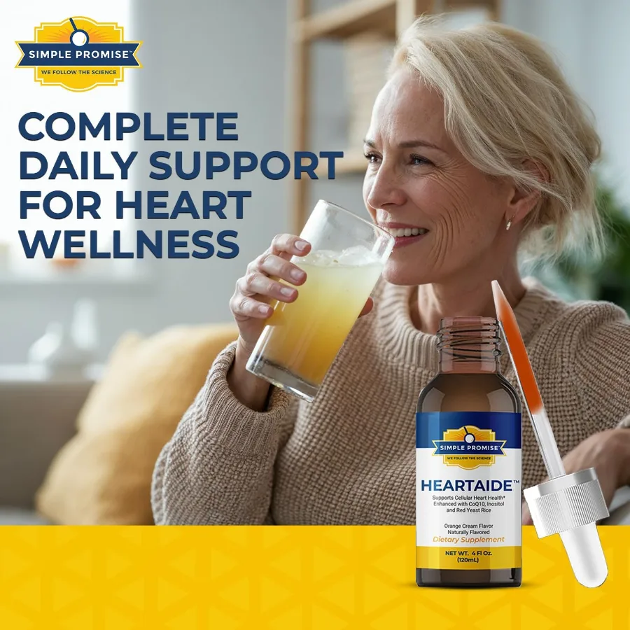 Smiling older woman drinking a glass of water next to a HeartAide bottle